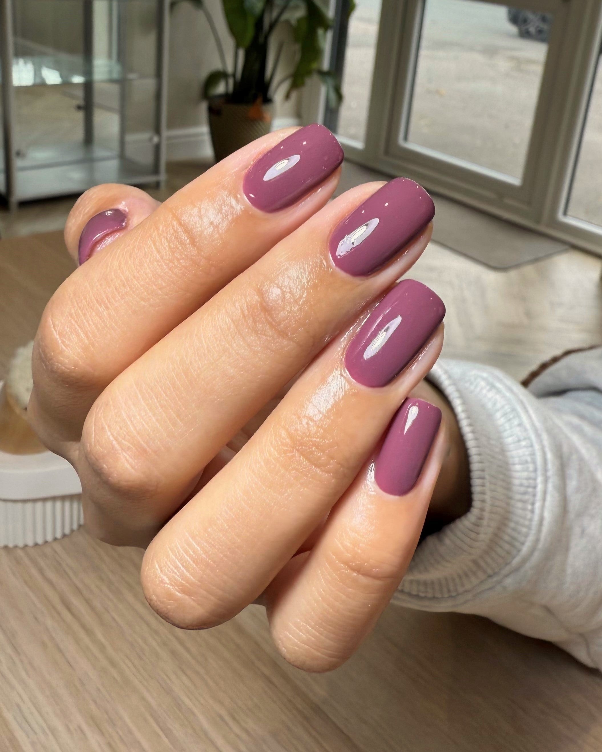 Photo of a deep purple TPO free nail gel with red and brown undertones.