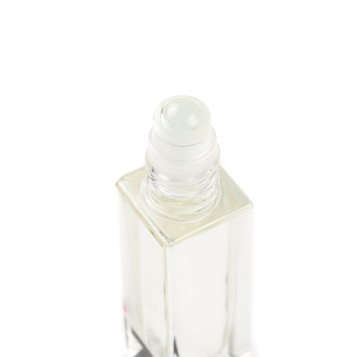 Clear glass roller bottle with a white cap on a white background filled with cuticle bottle.