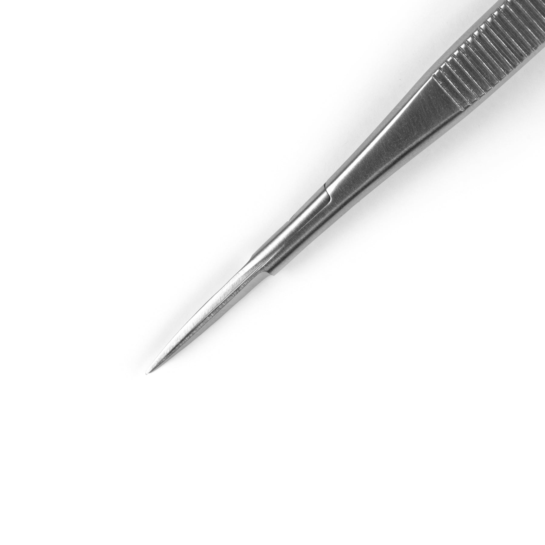 Pair of stainless steel cuticle scissors closed on a white background