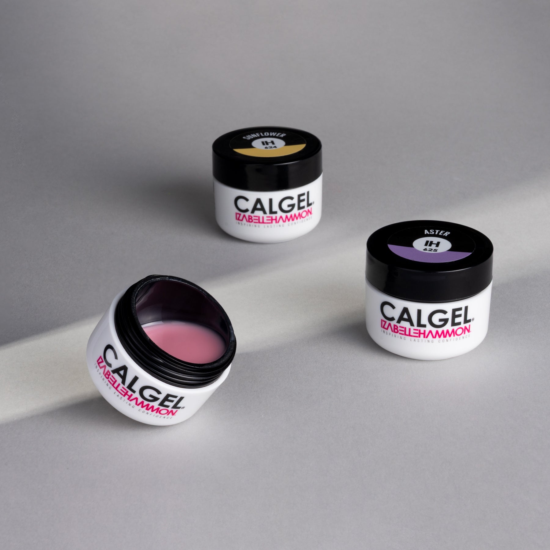 Three jars of Calgel nail gel pots on a gray background