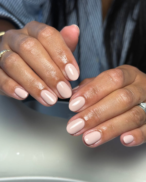 Close-up of hands with Ophelia a light light taupe nail gel available in Calgel and Pro Colour