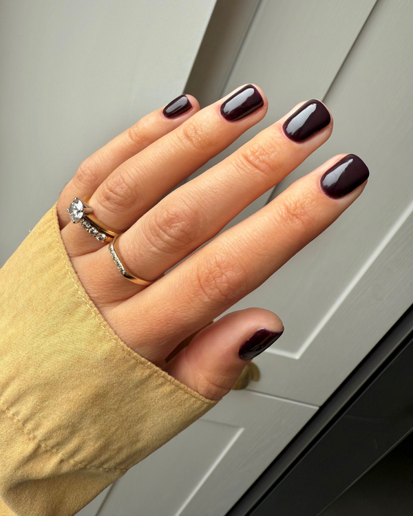 Hand wearing dark purple nail gel in Haunted in Calgel and Pro Colour