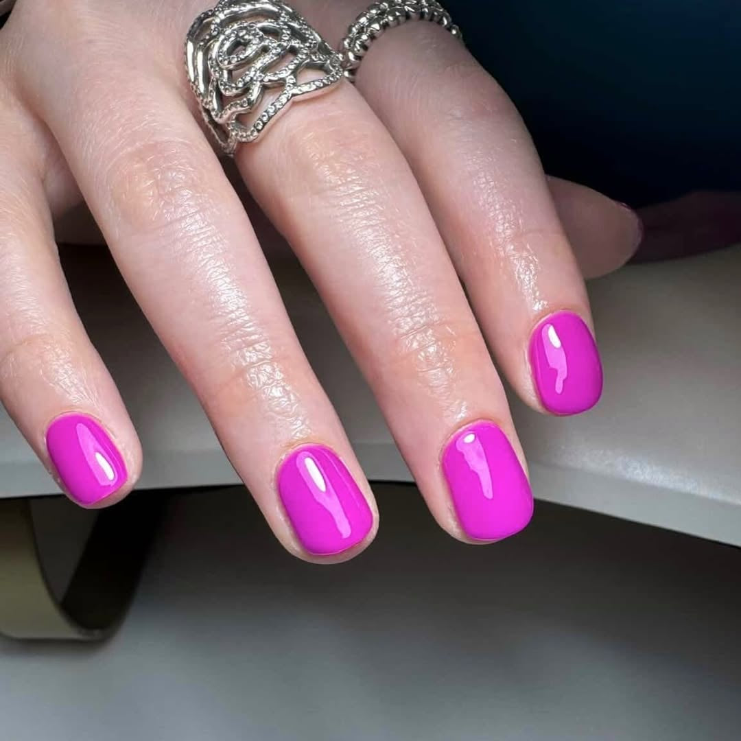 Hand with magenta pink nail gel in Calgel Dragon Fruit