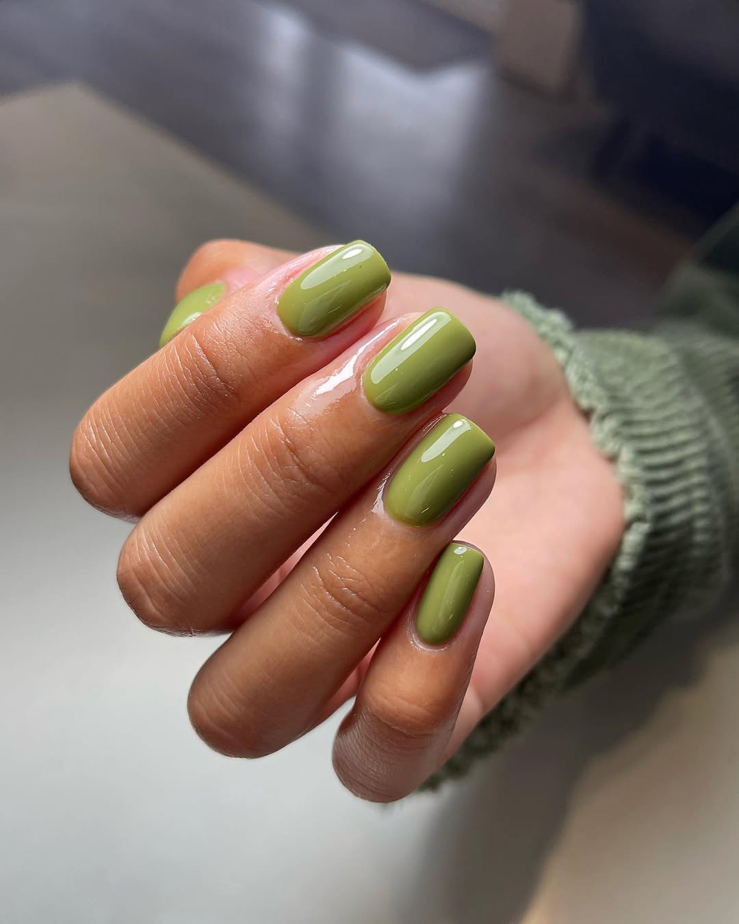 Hand with olive green nail gel Pro Colour grounded