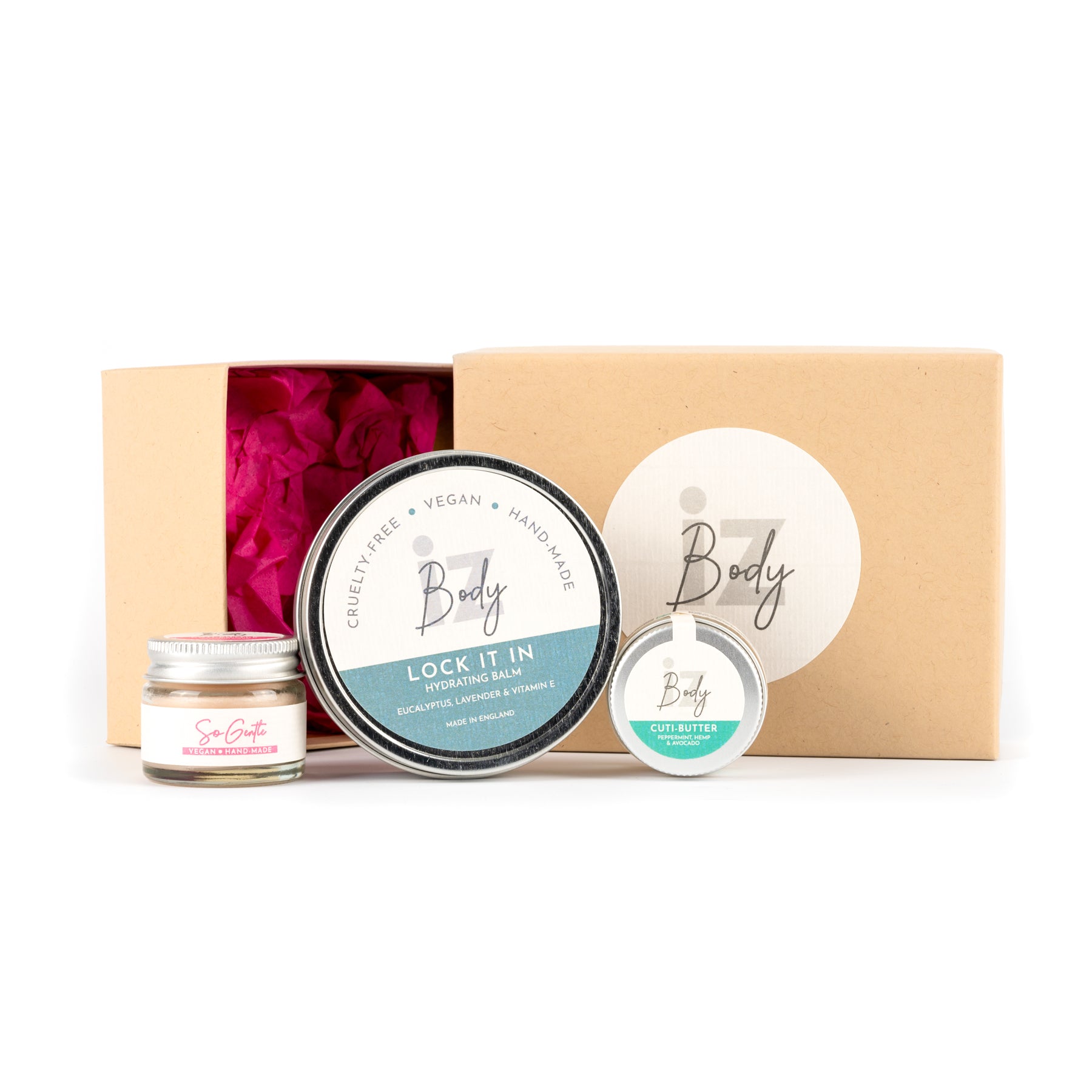 A set of three vegan hand and foot balms in a gift box, including 'Lock It In', 'So Gentle', and 'So Fresh' balms, with the brand 'iZ Body' displayed.