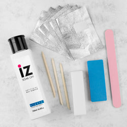 Gel soak-off kit with remover wraps, buffer block, nail file, and cuticle tool on a flatlay background.
